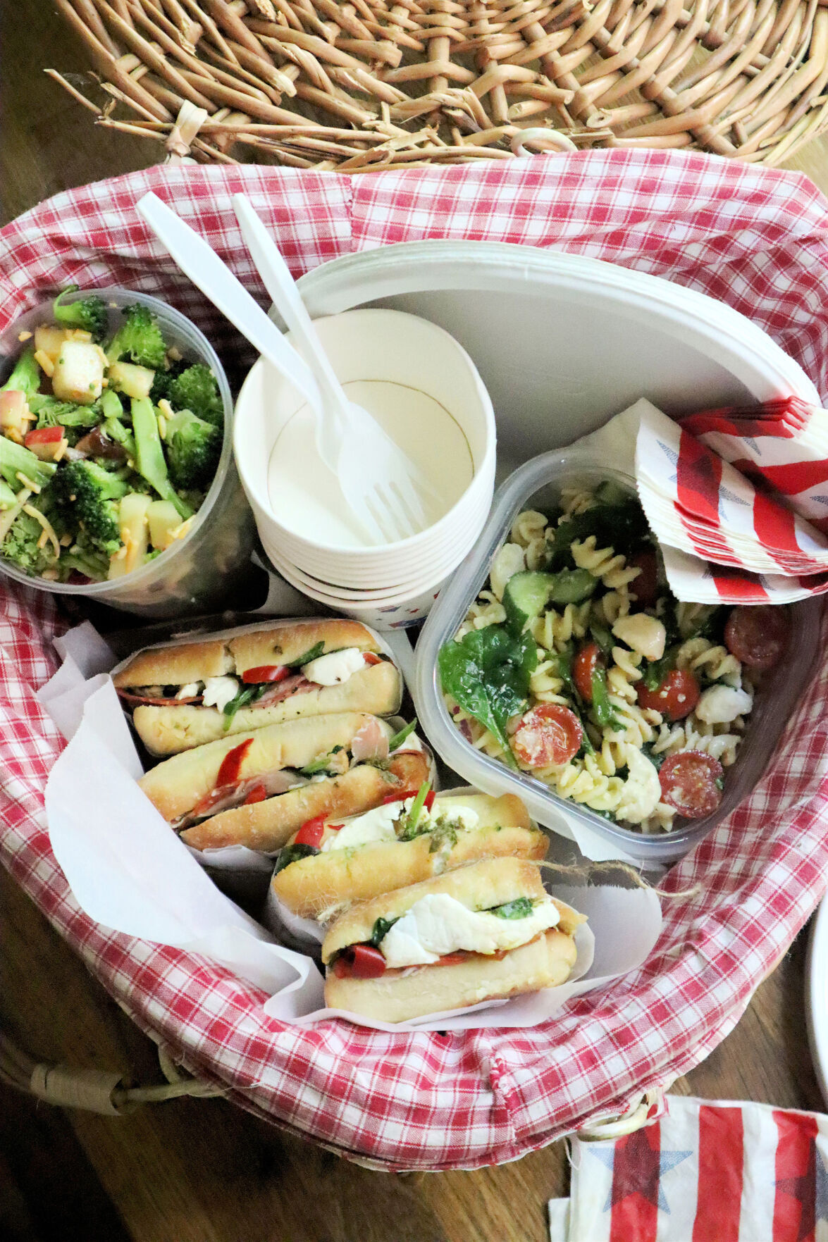 Foods that travel well on a summer roadtrip include, from left, broccoli salad with apple and dried cherries, pressed Italian sandwiches and pasta salad with fresh mozzarella.